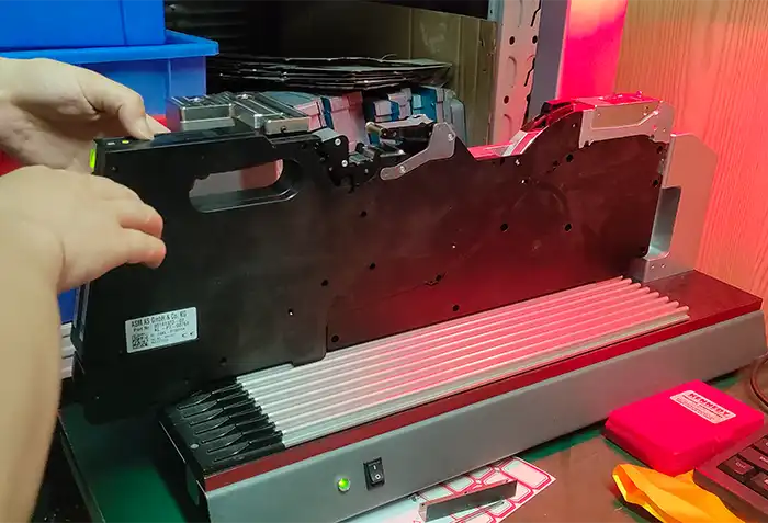 Engineers performing calibration on ASM feeders